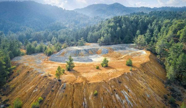 Restoration of abandoned mine site. Pine trees growing over copper and gold mine tailings in Paphos forest, Cyprus