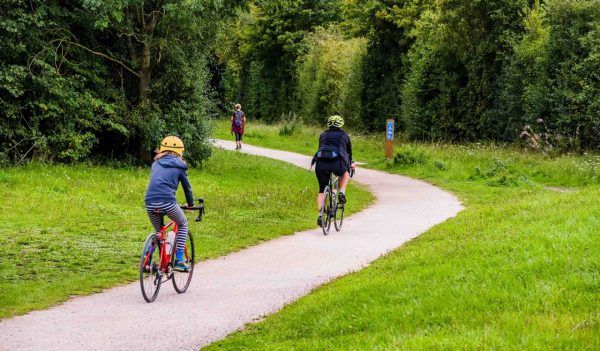 Cyclists on a shared path in a nature area.