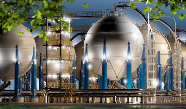 Hydrogen storage tanks and pipeline system at night.