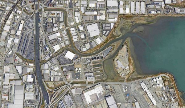 Aerial view of a port along side commercial buildigins and a freeway as part of the erosion control study.