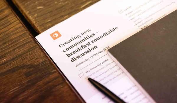 Close-up of the Roundtable discussion agenda on teh table with a pen sitting on it.