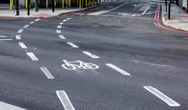 Bicycle road sign painted on the asphalt road. UK city street