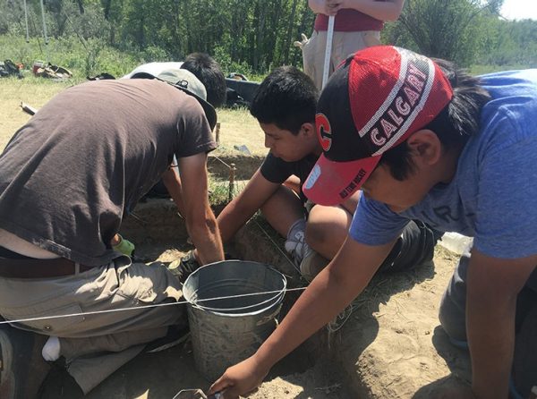 Students at an archaeology excavation site.