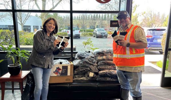 LeeAnn Rodriguez and Kary Faria standing in front of donated socks.