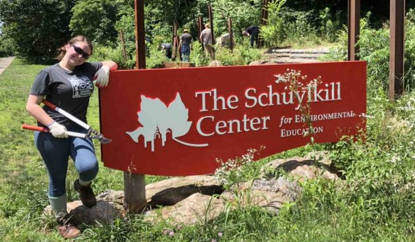 Jennifer Mulqueen standing beside a sign.