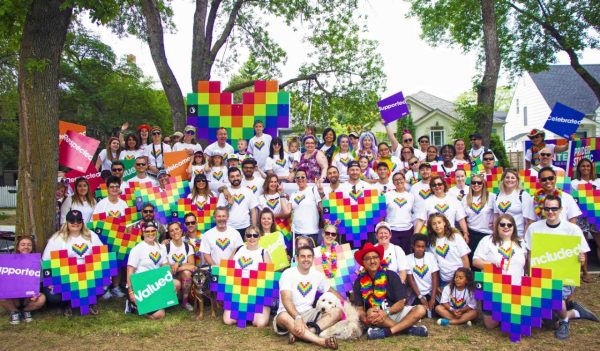 Group of Stantec employees gathered before the parade with colorful hearts