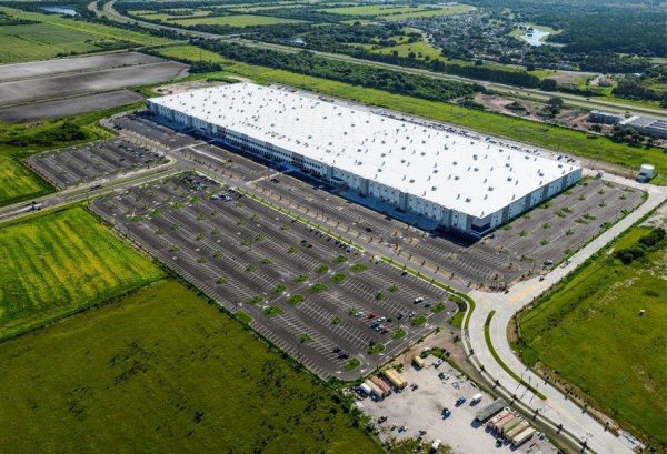 Aerial view of building and parking lot in an agricultural area