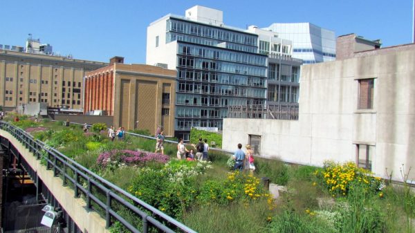 A garden on top of an overpass with people walking