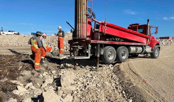 Workers and a piece of equipment on site