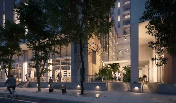 Street level entrance to the building with people and plantings