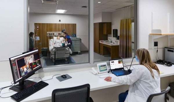 Interior training lab with patient care room and instructor area.