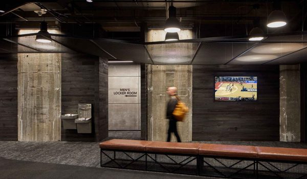 Man walking in hallway towards Men's locker room.