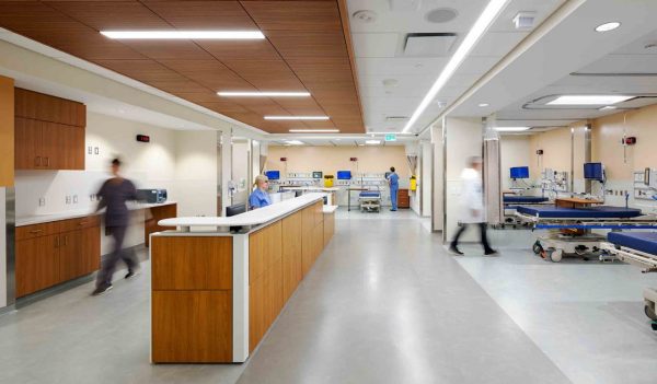 Emergency room area with beds and nursing station desk.