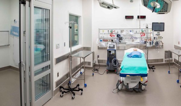 Interior hospital room with bed and equipment.