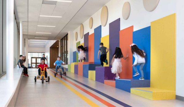 Corridor with steps on one side and children playing