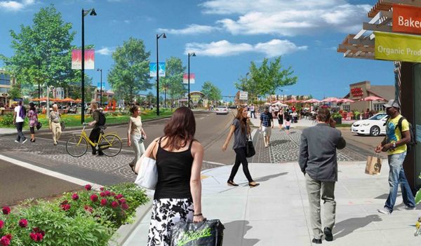 People walking along a street with shops and landscaping