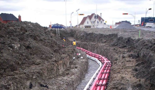 Telecommunications cabel being laid in the ground a new construction area