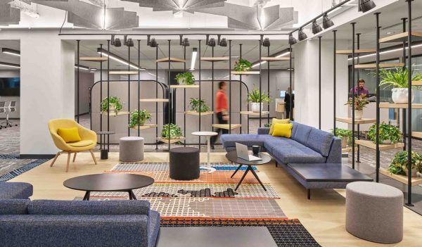 Open gathering area with a variety of seating and open shelving as a divider