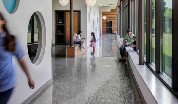 Hallway with kids sitting on a bench and at the window