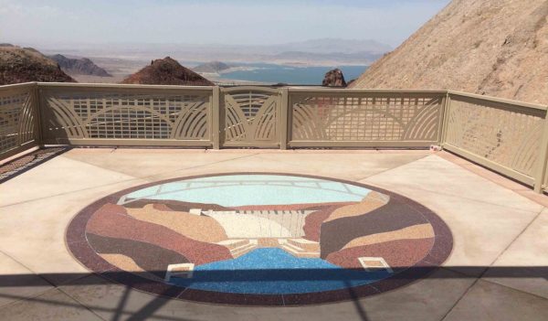 View of a lake and mountains from a lookout with architectural details