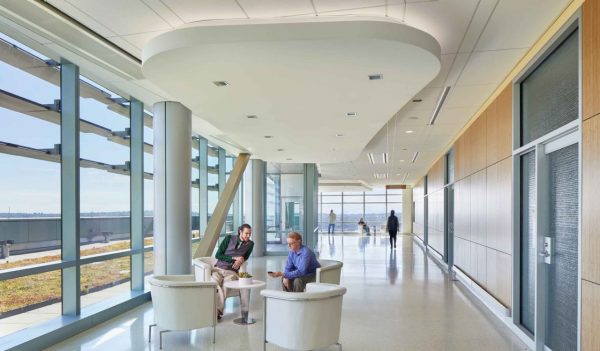 Interior corridor with seating and large windows with views to the outdoors