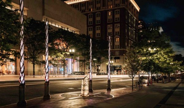 The memorial poles lit up at night