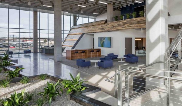 Interior lobby with seating, plants, and a view to the city