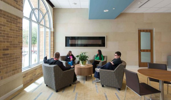 A group sitting on chairs in a lounge space