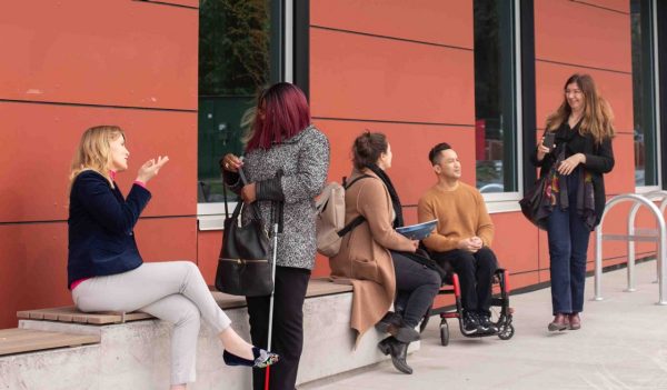 A group of people talking outside a building