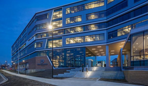 Exterior building entrance lit up at night