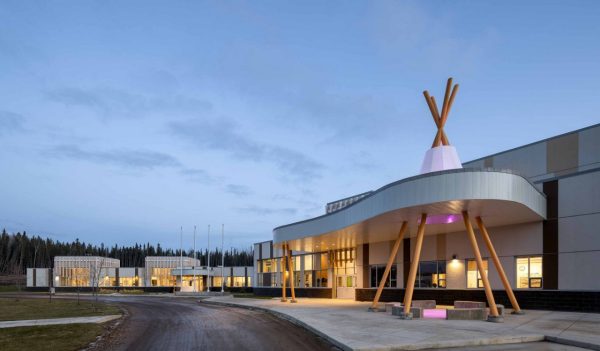 Exterior of school front entrance with architectural detailing representing a teepee