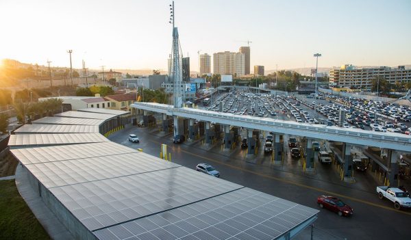 Aerial view of cars lined up at border crossing entry point.