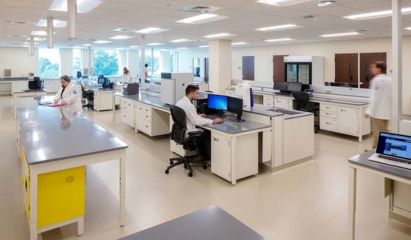 People working at tables in a lab.