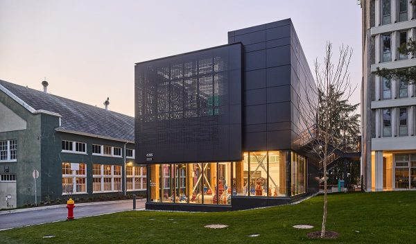 Exterior of building at dusk with interior lights on.