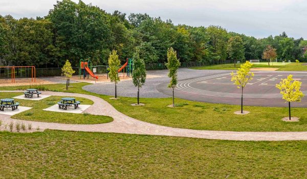 School yard with picnic tables and trees