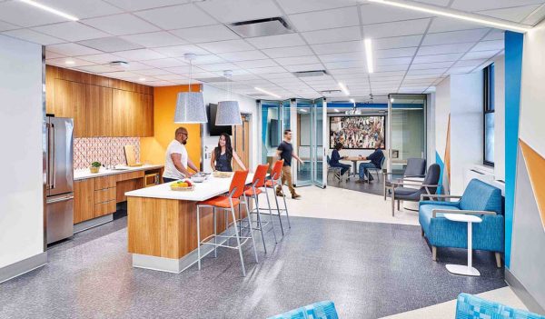 Employee lounge area with kitchen and seating.