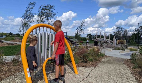 Children playing on equipment at a neighborhood playground.