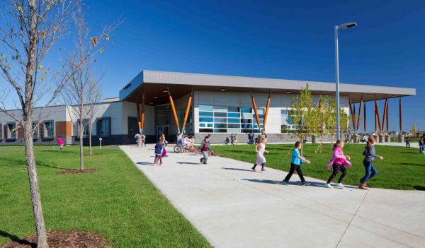 Children playing outside of the school building.