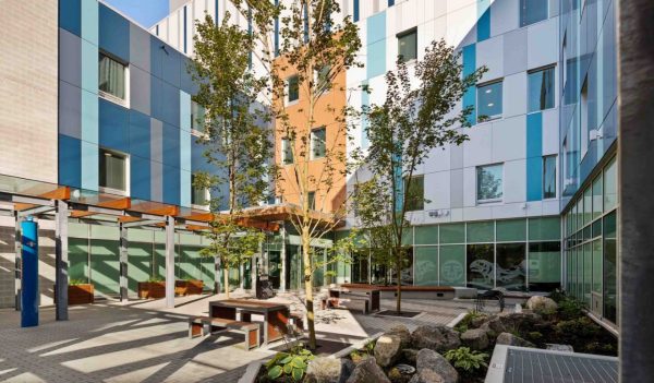 Exterior courtyard with tables and landscaping.