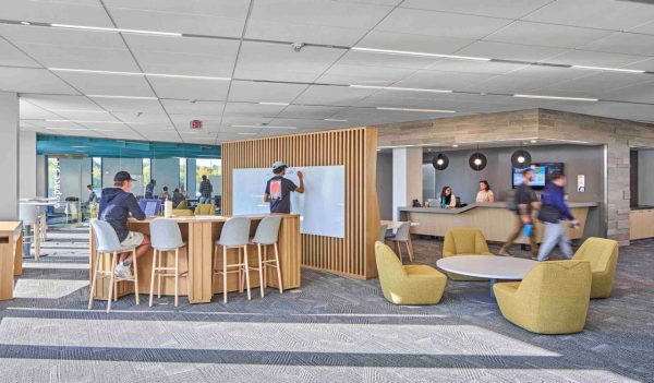 Interior common area with seating and a whiteboard.