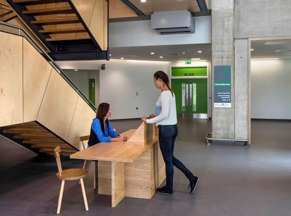 Rendering of information desk near a staircase.