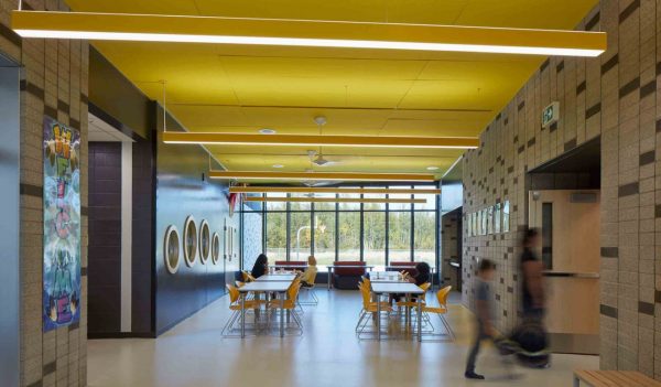 School interior - student common area with tables near a large window.