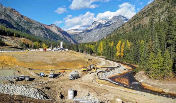 View of construction site and work reinforcing river bank.