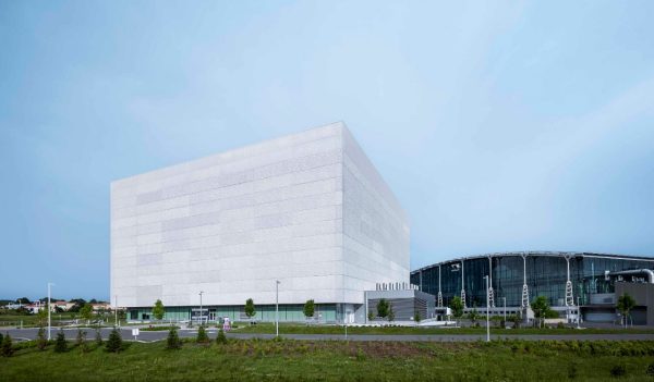 White cube-shaped building with a blue hazy sky