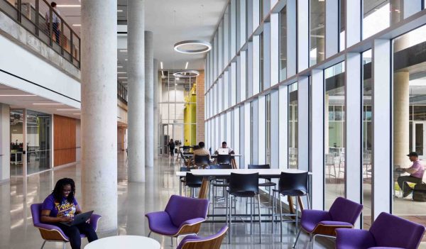 Two story corridor with seating and views to the outdoors