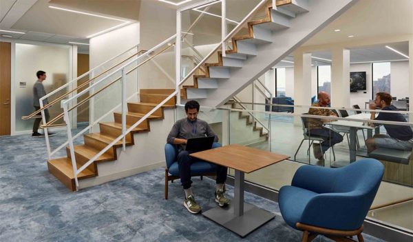 Seating area in an open area with stairs to upper floor