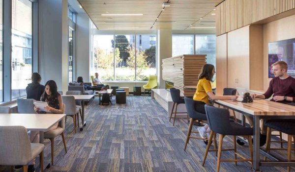 Interior common area for with tables and large windows.