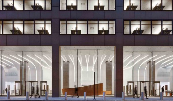 Exterior of the building front at street level showing the large lobby windows and floors above.