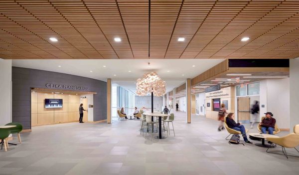 Interior view of a student common area with tall table and conversation s seating 