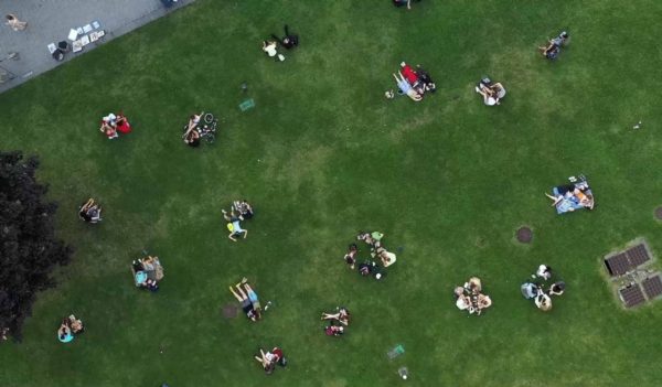 People rest on the green lawn at the end of the day